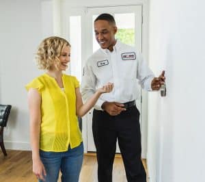 Tech and customer with thermostat