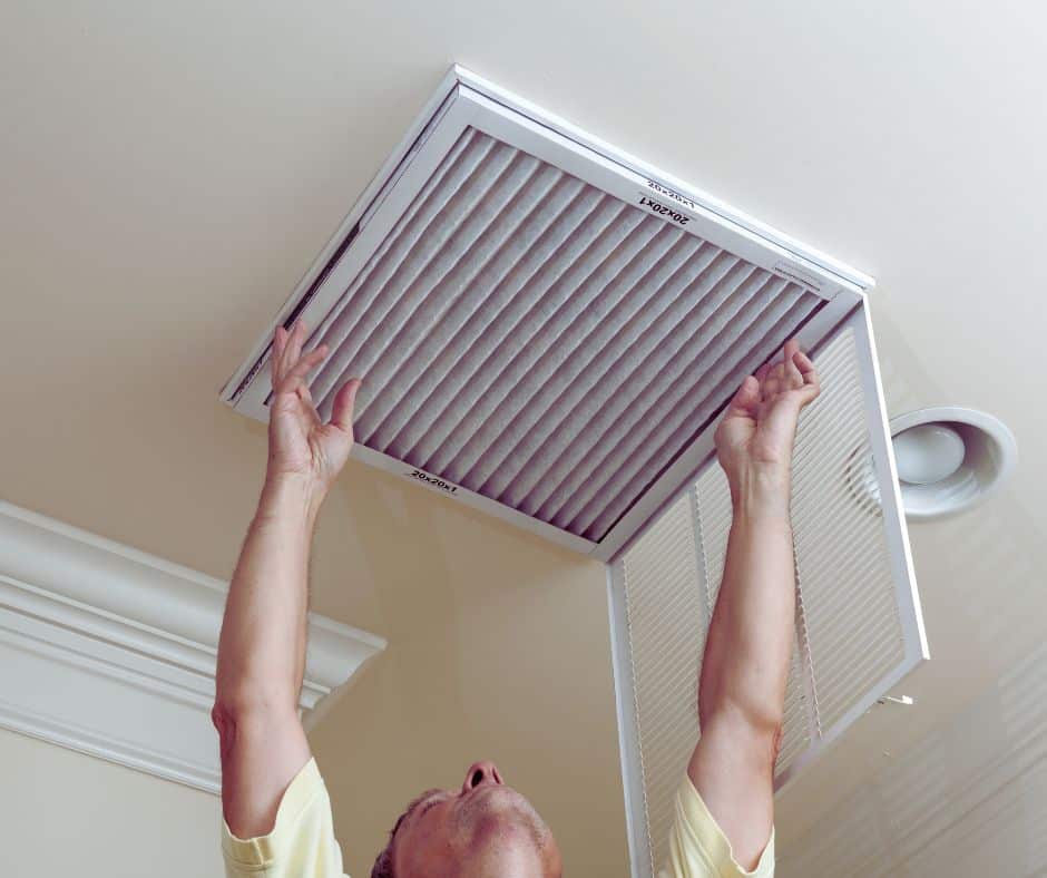 The Big Spring Clean for Your HVAC System: 5 Things Homeowners Can Do Safely (And When to Call Us) Man replacing air filter