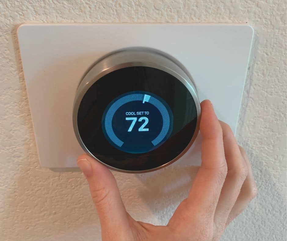 Person setting thermostat