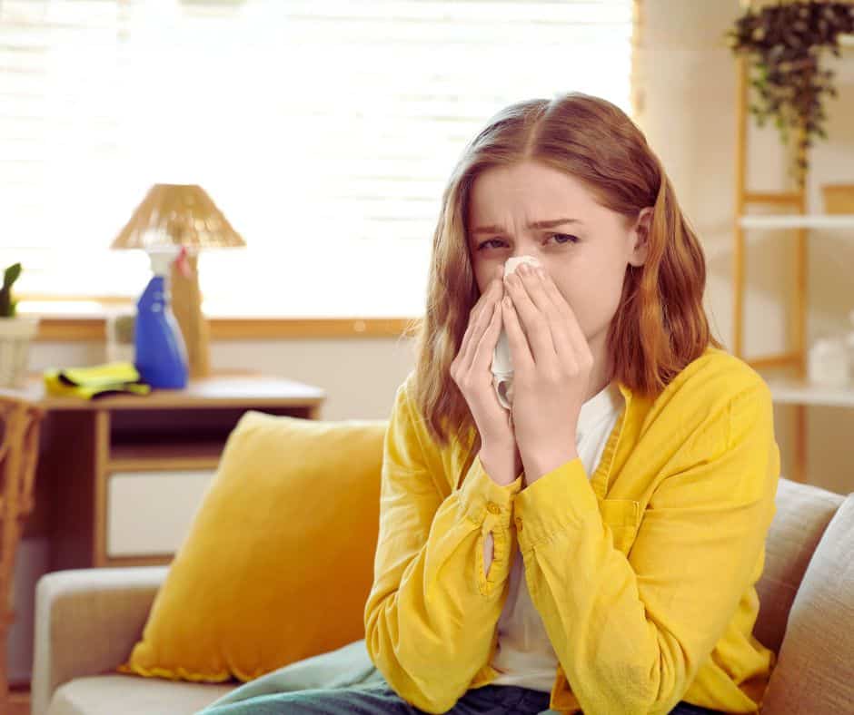 Why Your Home Feels Worse During Allergy Season—And What Your AC Is Trying to Tell You woman with indoor allergies